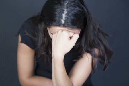 Attractive woman desperate on black backgroundの写真素材