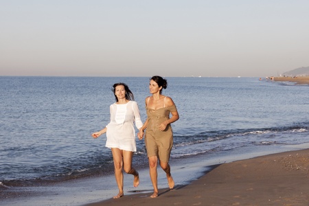 Two women being happy on a beachの写真素材