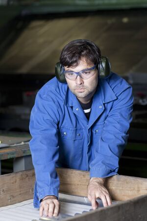 Handsome blue collar worker in factory  