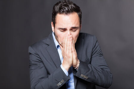 Businessman with depression on grey backgroundの写真素材