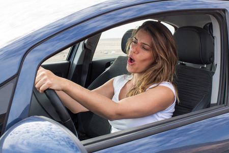 Attractive woman in car singing