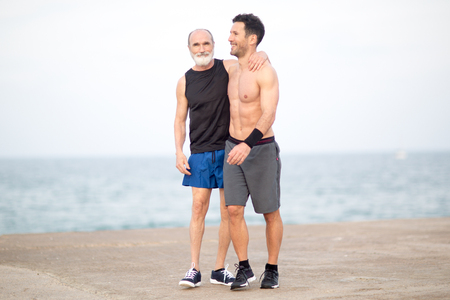 Athlete relaxing with coach after trainingの写真素材