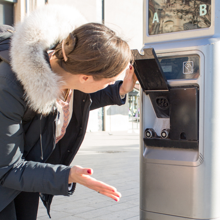Woman confused with electric car charger
