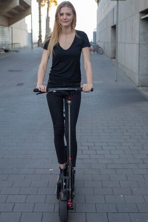 Woman riding an electric scooterの写真素材