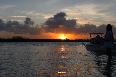 A beautiful sunset to match the beautiful girl in the foregroundの素材