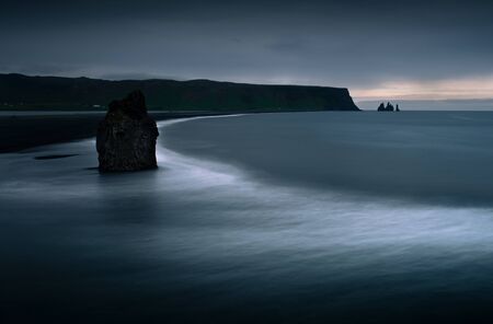 Scenic view from Dyrholaey to Reynisfjara beach against cloudy sky during sunset. View from Dyrholaey penisulaの写真素材