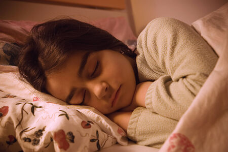 sweet little girl sleeping in her bedの写真素材