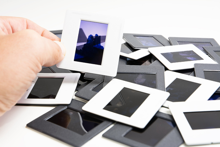 Frame in the hand with diapositive in backgroundの写真素材