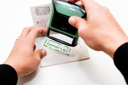 Stamping passport with green stamp approvedの写真素材