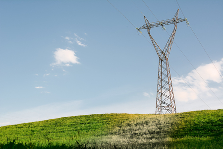 Elettromagnetic pollution of Pylon on green hillの写真素材