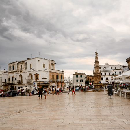 Ostuni, Italy - 17.08.2016: Freedom square and statue of Sant'Oronzo in Ostuni with touristのeditorial素材