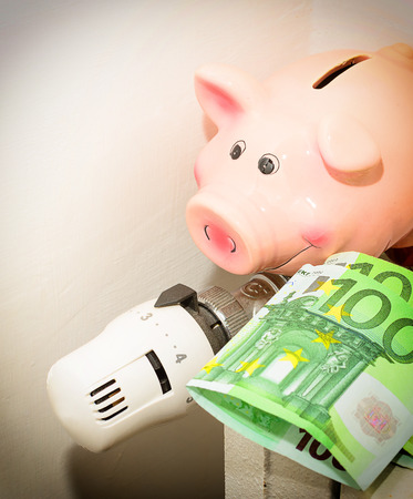 Concept Piggy, the valve on the radiator for saving energy and moneyの写真素材