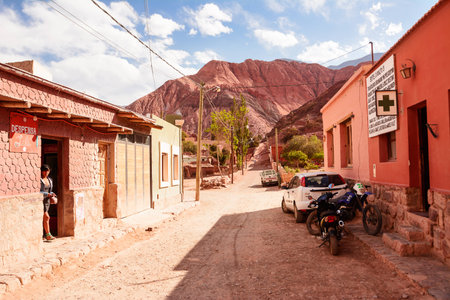 Purmamarca, Argentina - November 1, 2016: Street in Purmamarca with indigen woman and car (Argentina)のeditorial素材