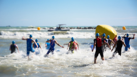 Starting for the swimming test of the athletes of triathlon, blurredのeditorial素材