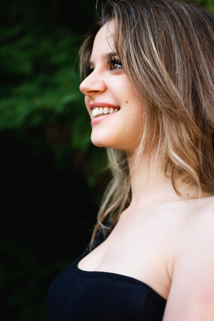 Profile of a beautiful smiling girlの写真素材