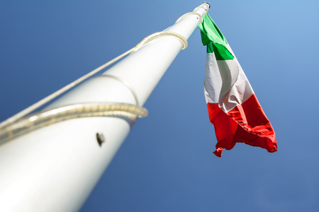 The Italian flag in blue skyの写真素材