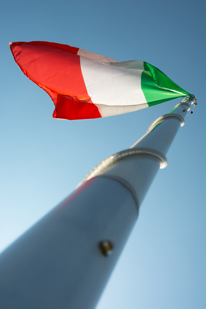 The Italian flag in blue skyの写真素材