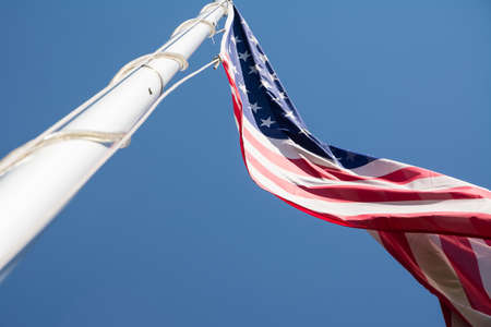 The US flag in blue skyの写真素材