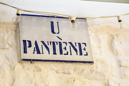 Road sign with street dialect name in a Puglia roadのeditorial素材
