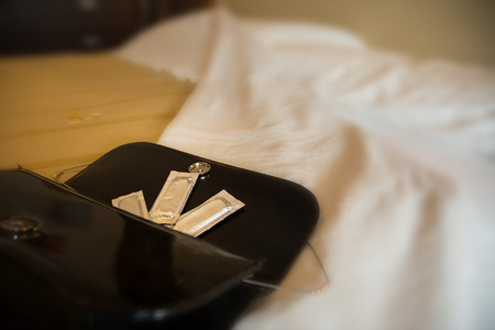 open female handbag and condomsの写真素材