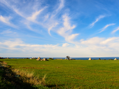Ancient trulli, countryside, sea and clouds in Pugliaの写真素材
