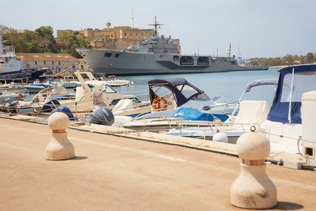 Brindisi, Italy - April 30, 2018: Porto di Brindisi con barche e nave militare ormeggiata nel portoのeditorial素材