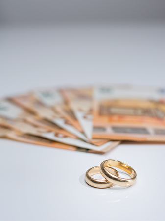 Wedding rings and banknotesの写真素材