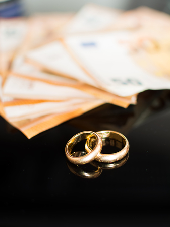 Wedding rings and banknotesの写真素材