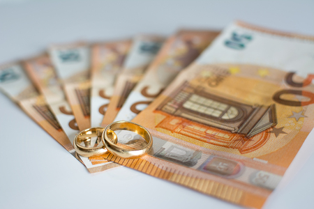 Wedding rings and banknotesの写真素材