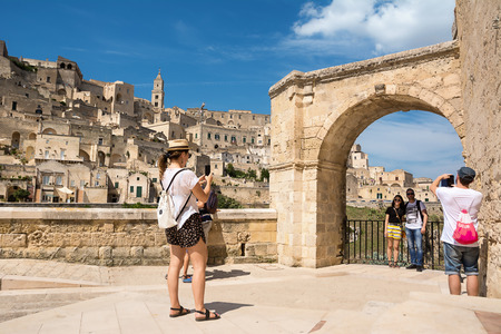 Matera, Italy - August 18, 2018: Tourists take selfies and snapshots with the background of Matera in a sunny dayのeditorial素材
