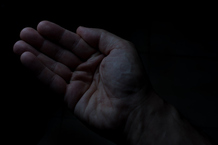 One hands of  man in black background