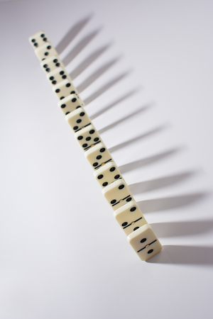 domino tiles in a row on a white backgroundの写真素材