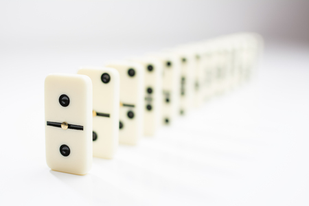 domino tiles in a row on a white backgroundの写真素材