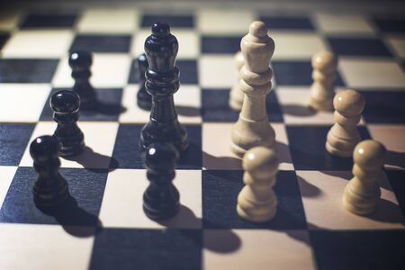 the chessboard with Black Queen and white Queen in front in the concept of agreement with arounds...