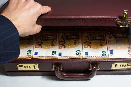 24-hour half-open briefcase full of euro banknotesの写真素材
