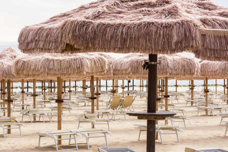 Palm umbrellas on the beach in Pescara (Abruzzo-Italy)の写真素材