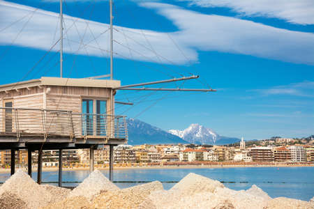 Trabucco al porto, overlooking the Pescara seafront, with the bell tower of the Divino Amore church and the Gran Sasso mountainの写真素材