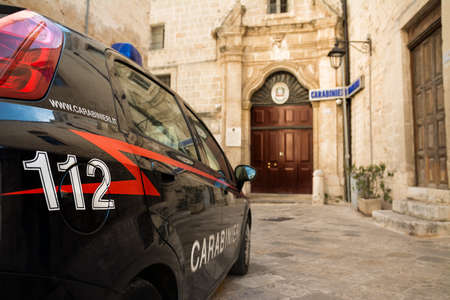 Carabinieri car with the emergency number 112 in the foreground and in the background the police station of Monopoli (Puglia-Italy)の写真素材
