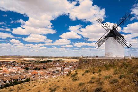 Windmill on the hill and in the background the village of Consuegra, Spainの写真素材