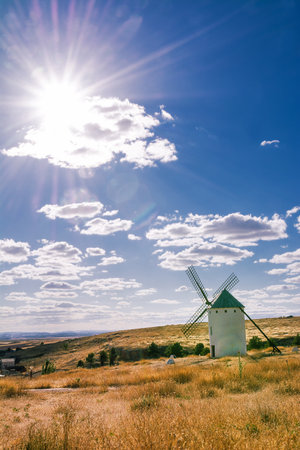 Ancient windmill in the campo in Campo de Criptana, Spain, defined in Cervantes' Don Quixote "The Giants", and the sun with its raysのeditorial素材