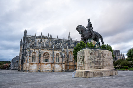 Square with monument in front of Batalha Cathedral in Portugalの写真素材
