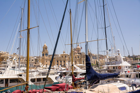 Vittoriosa, Malta - 17 June 2023: Collegiate Church of Saint Lawrence, seen through masts of boats sails, Vittoriosaのeditorial素材