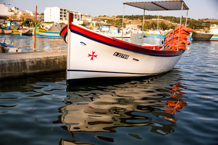 Marsaxlokk, Malta - 18 June 2023: typical Maltese boat, called luzzo, with the traditional eyes and Maltese cross drawn on the bowのeditorial素材