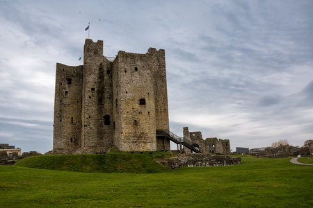 Trim, Ireland - 04 April, 2025: Trim Castle with clouds over green grass fieldの写真素材