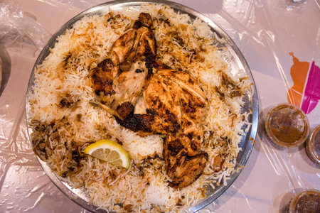 Arabian biryani dish with rice and chicken served on a traditional platterの写真素材