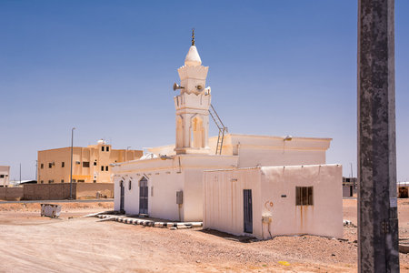 Small village mosque in Saudi Arabia, completely white with its minaret and loudspeakersの写真素材