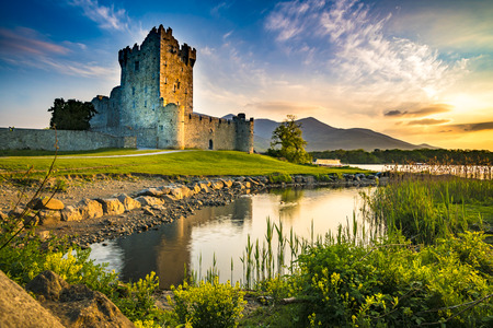 Ancient old Fortress Ross Castle ruin with lake and grass in Ireland during golden hour nobodyの写真素材
