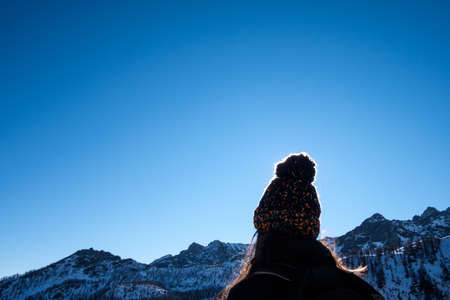 backlight of woolen hat on blue sky background in mountains alps in Italy with space for copy textの写真素材