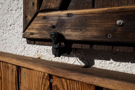 man-shaped shutter stop with stop stop, wooden detail at the dondena refuge in the aosta valley, italyの写真素材
