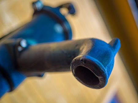Green manual water pump in the front of the houseの写真素材